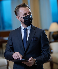 Image showing business man wearing protective face mask at office