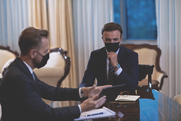 Image showing business people wearing crona virus protection face mask on meeting