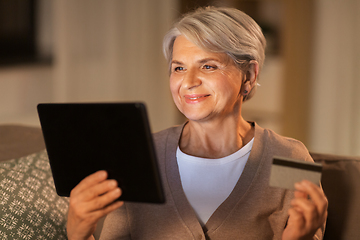 Image showing old woman with tablet pc and credit card at home