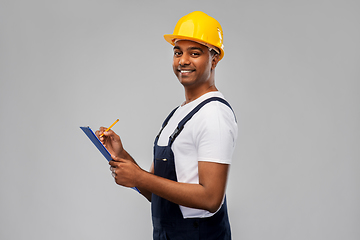 Image showing happy builder in helmet with clipboard and pencil