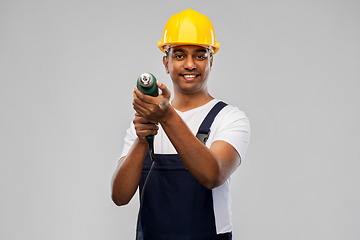 Image showing happy indian builder in helmet with electric drill