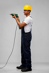 Image showing happy indian builder in helmet with electric drill