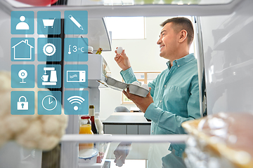 Image showing man taking eggs from fridge at kitchen