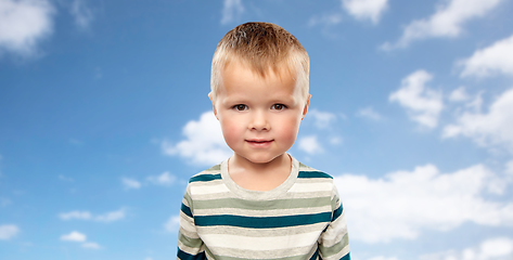 Image showing little boy in striped shirt over blue sky