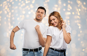 Image showing portrait of happy couple in white t-shirts dancing