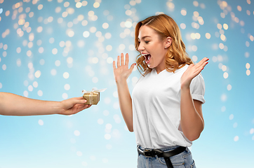 Image showing happy couple in white t-shirts with christmas gift