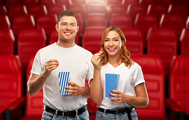 Image showing happy couple eating popcorn at movie theatre