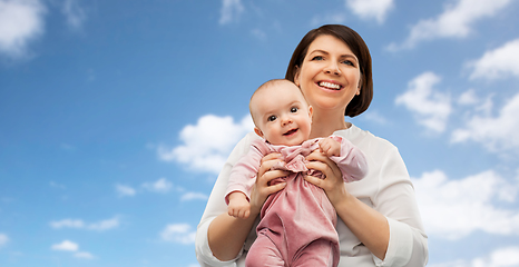 Image showing happy middle-aged mother with little baby daughter