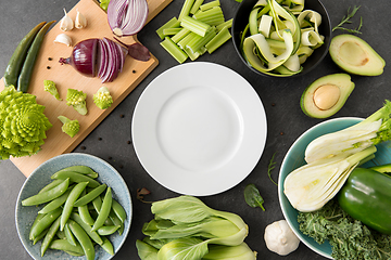 Image showing different green vegetables and white empty plate