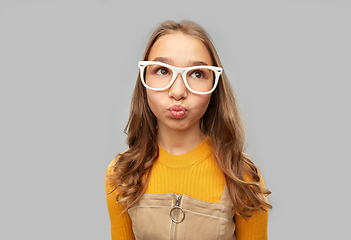 Image showing teenage student girl in glasses making faces