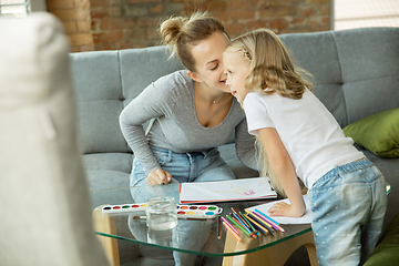 Image showing Teacher and little girl, or mom and daughter. Homeschooling concept