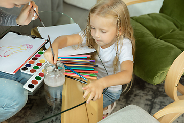 Image showing Teacher and little girl, or mom and daughter. Homeschooling concept