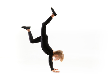 Image showing Female little gymnast practicing isolated on white background