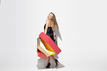 Image showing Young woman in dress shopping on white background