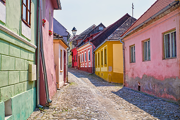 Image showing Stone paved road and colorful houses