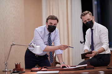 Image showing business people wearing crona virus protection face mask on meeting