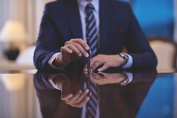 Image showing corporate businessman at luxury office pen holding 