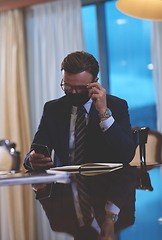 Image showing business man wearing protective face mask at office