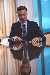 Image showing business man using smart phone at luxury office