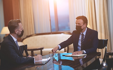 Image showing business people wearing crona virus protection face mask on meeting