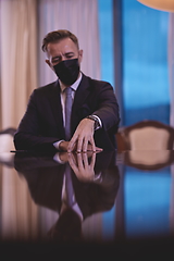 Image showing business man wearing protective face mask at luxury office