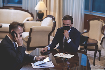 Image showing business people wearing crona virus protection face mask on meeting