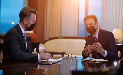 Image showing business people wearing crona virus protection face mask on meeting