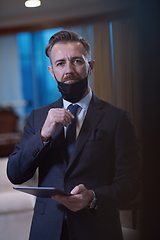 Image showing business man wearing protective face mask at office