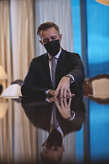 Image showing business man wearing protective face mask at luxury office