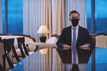 Image showing business man wearing protective face mask at luxury office