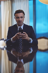 Image showing business man using smart phone at luxury office