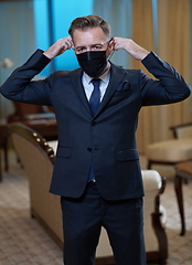 Image showing business man wearing protective face mask at office