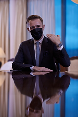 Image showing business man wearing protective face mask at luxury office