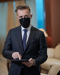 Image showing business man wearing protective face mask at office