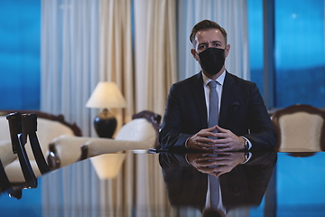 Image showing business man wearing protective face mask at luxury office