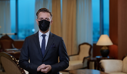 Image showing business man wearing protective face mask at office