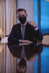 Image showing business man wearing protective face mask at luxury office