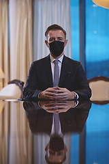 Image showing business man wearing protective face mask at luxury office