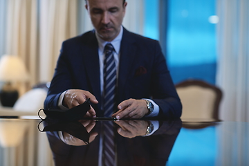 Image showing business man using smart phone at luxury office