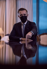 Image showing business man wearing protective face mask at luxury office