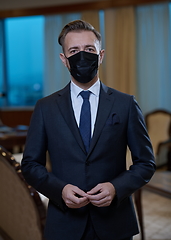 Image showing business man wearing protective face mask at office