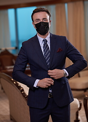 Image showing business man wearing protective face mask at office