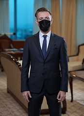 Image showing business man wearing protective face mask at office