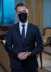 Image showing business man wearing protective face mask at office