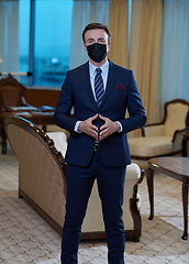 Image showing business man wearing protective face mask at office