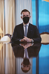 Image showing business man wearing protective face mask at luxury office