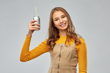 Image showing happy teenage girl drinking soda from can