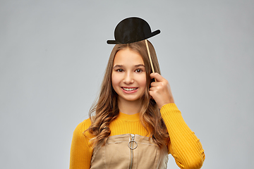 Image showing smiling teenage girl with black vintage bowler hat