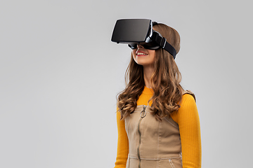 Image showing teenage girl in vr glasses over grey background
