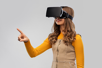 Image showing teenage girl in vr glasses over grey background